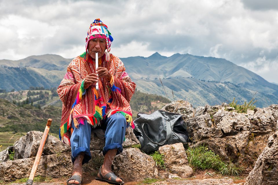 Quechua Man playing the Flute in Peru. Photo: Black Tomato
