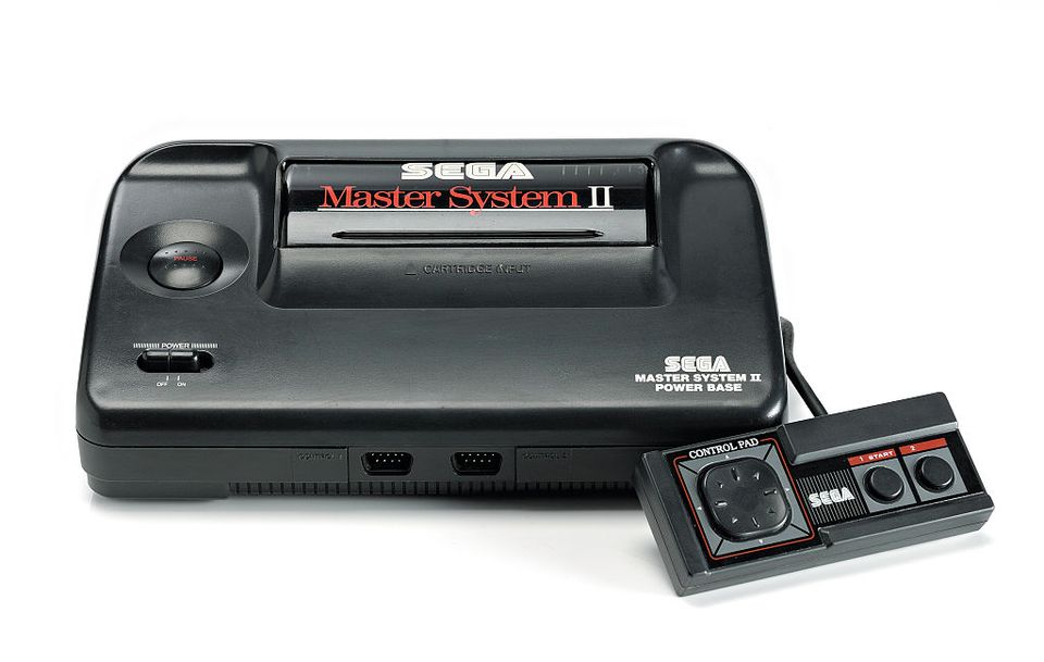 A Sega Master System video game console and controller photographed on a white background, taken on March 26, 2009. (Photo by Neil Godwin/GamesMaster Magazine via Getty Images)
