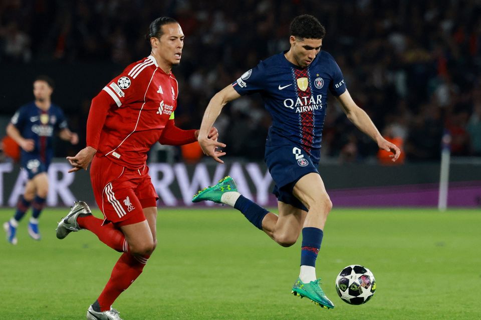 Liverpool's Virgil van Dijk in action with Paris St Germain's Achraf Hakimi. Photo: Reuters/Stephanie Lecocq