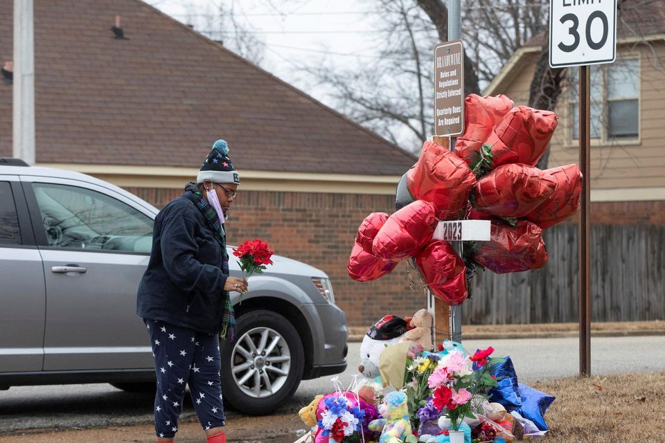 A woman places flowers at a memorial for Tyre Nichols in Memphis, Tennessee. Photo: Reuters
