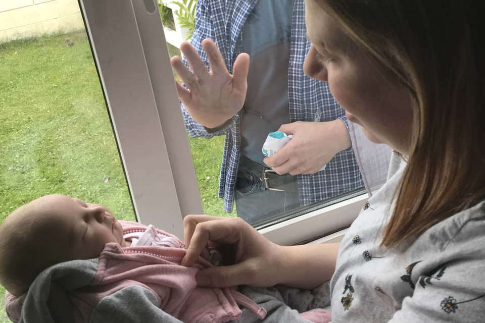 Emily Watson introducing baby Charlotte Hope through the window to grandad Neville