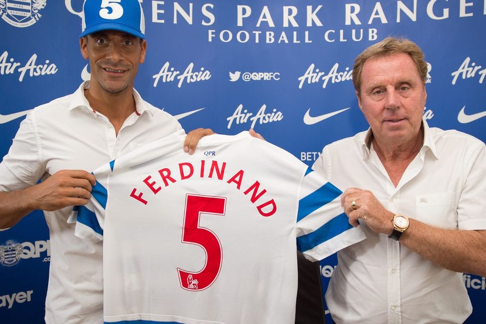 Rio Ferdinand (left) and Queens Park Rangers manager Harry Redknapp pose for photographs at a press conference to unveil the former Manchester United defender as the club's latest signing. Photo: LEON NEAL/AFP/Getty Images