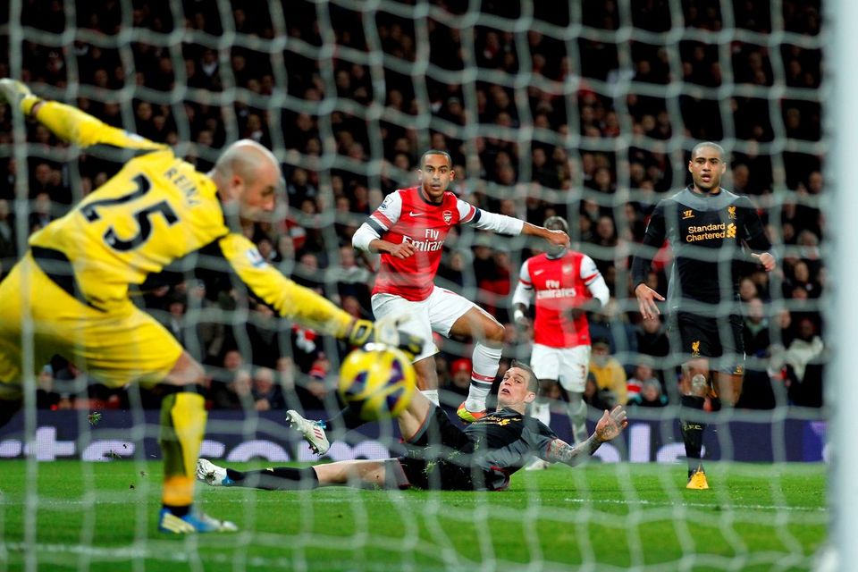 Arsenal's English striker Theo Walcott scores a goal beating Liverpool's Spanish goalkeeper Pepe Reina to take the score to 2-2 during the English Premier League football match between Arsenal and Liverpool at The Emirates Stadium, January 30, 2013