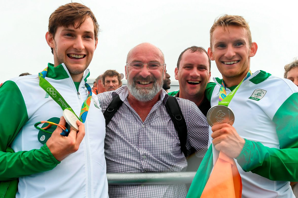 Paul (left) and Gary O’Donovan are congratulated by their father Teddy after the final. Photo: Brendan Moran