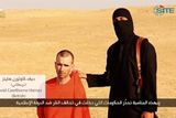 thumbnail: A masked, black-clad militant, who has been identified by the Washington Post newspaper as a Briton named Mohammed Emwazi, stands next to a man purported to be David Haines in this still image from a video obtained from SITE Intel Group website February 26, 2015