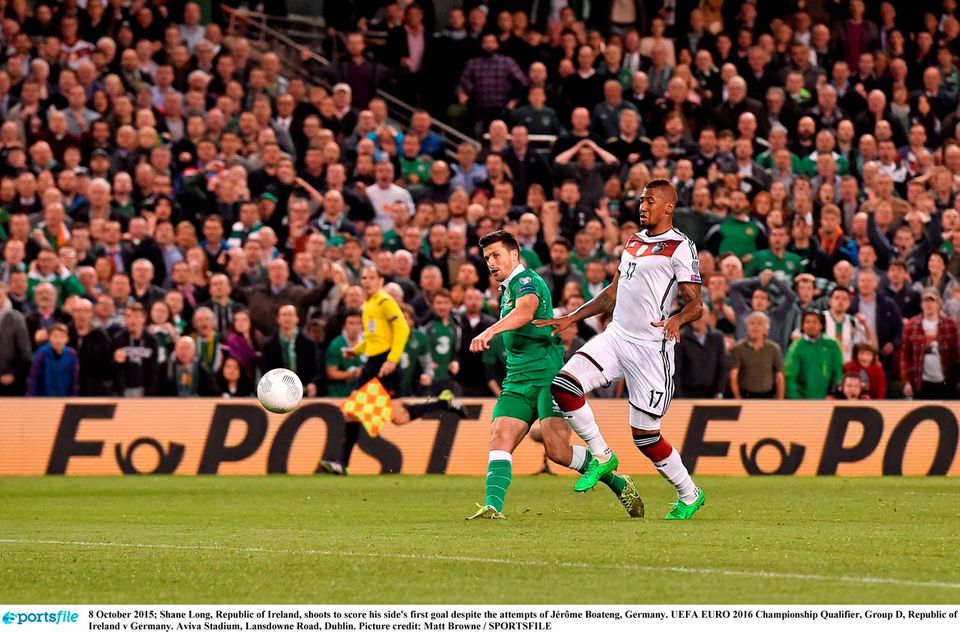 Shane Long, Republic of Ireland, shoots to score his side's first goal despite the attempts of J?r?me Boateng, Germany. UEFA EURO 2016 Championship Qualifier, Group D, Republic of Ireland v Germany. Aviva Stadium, Lansdowne Road, Dublin. Picture credit: Matt Browne / SPORTSFILE