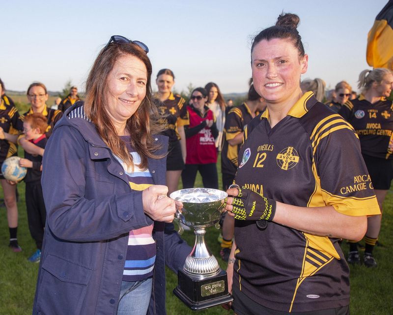 Anne Healy presents Avoca captain Tanya McDonald with the Junior B League trophy after her side defeated Eire Og in Ballinakill 