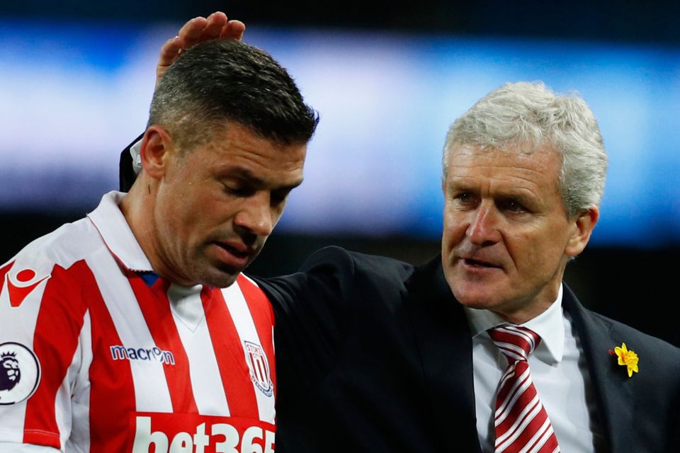 Stoke boss Mark Hughes congratulates Irish striker Jon Walters on a job well done against Manchester City last night Picture: Reuters