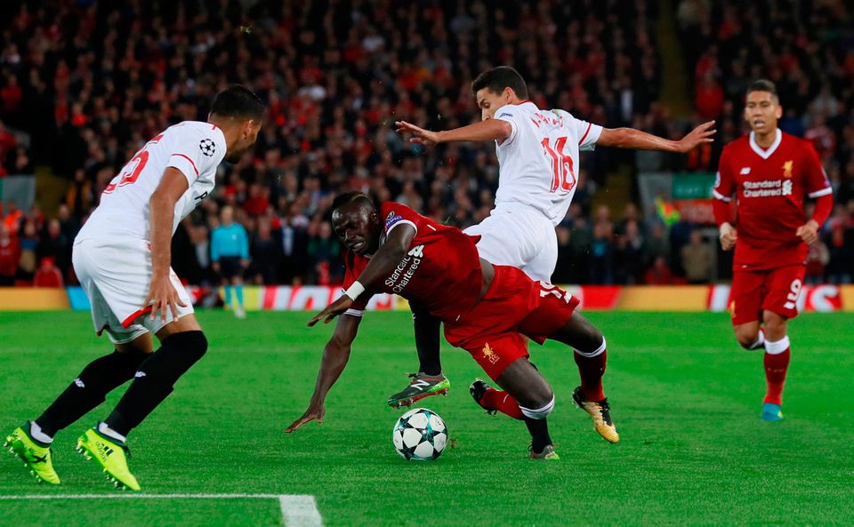 Liverpool's Sadio Mane tumbles after a challenge from Sevilla’s Jesus Navas. Photo: REUTERS