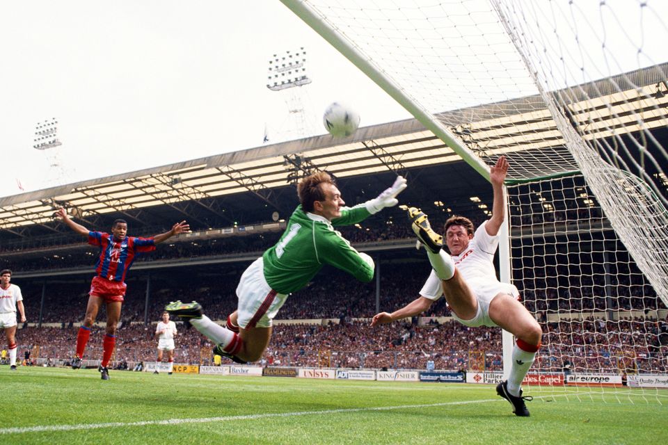 Crystal Palace striker Mark Bright celebrates as Manchester United goalkeeper Jim Leighton and defender Steve Bruce fail to keep out the first Crystal Palace goal scored by Gary O' Reilly (not pictured) during the 1990 FA Cup final at Wembley Stadium.
