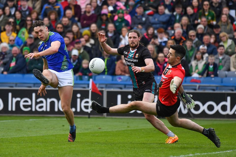 Kerry's David Clifford shoots past Pádraig O'Hora and Mayo goalkeeper Rory Byrne to score his side's third goal during the 2022 NFL Division 1 final. Photo: Ray McManus/Sportsfile
