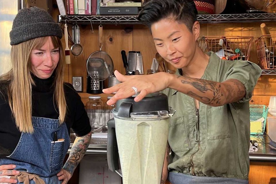 Chefs Carolynn Ladd and Kristen Kish blend ingredients while cooking together in the kitchen at Ladd's restaurant in North Haven, Maine. (National Geographic/Missy Bania)