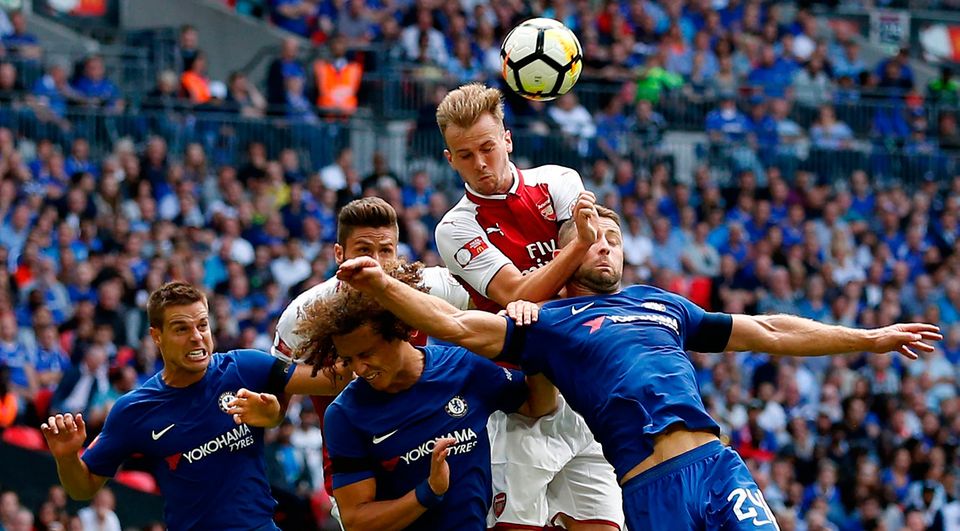 Arsenal's English defender Rob Holding (C) goes up for a header. Photo: Getty Images