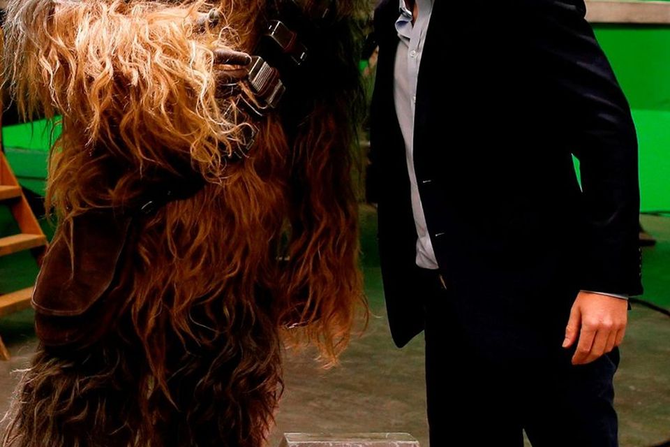 Britain's Prince Harry (R) speaks with Chewbacca during a tour of the Star Wars sets at Pinewood studios in Iver Heath, west of London on April 19, 2016.AFP PHOTO / ADRIAN DENNISADRIAN DENNIS/AFP/Getty Images
