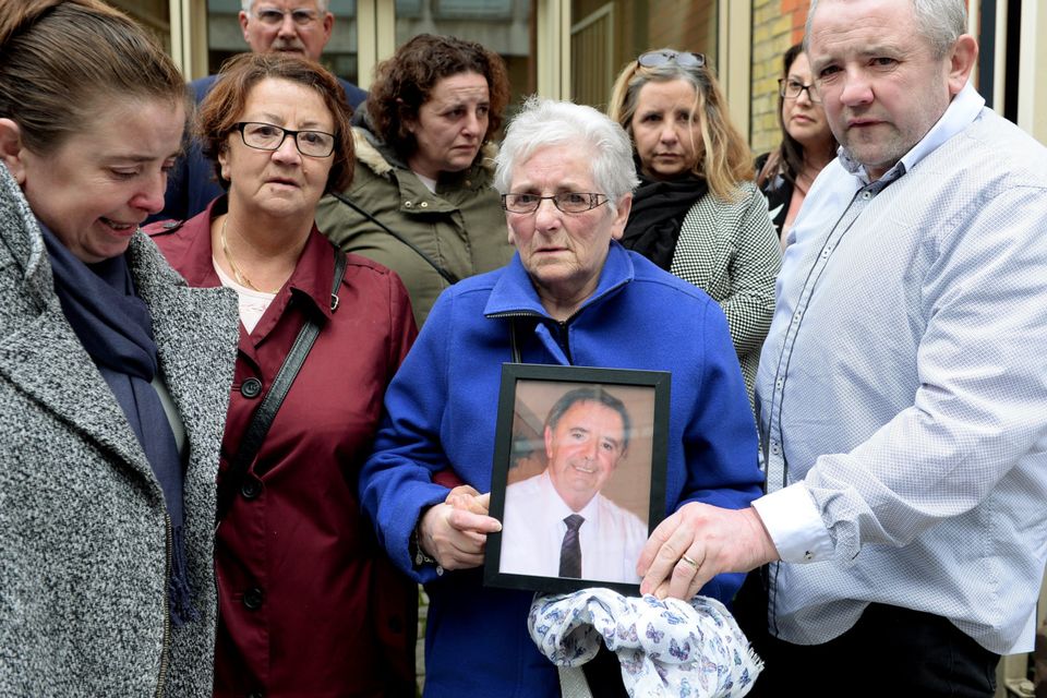 Ellen Hackett holding a photo of her late husband John Hackett, surrounded by her family, after the inquest into his death. Coroner's Court, Store Street, Dublin. Picture: Caroline Quinn