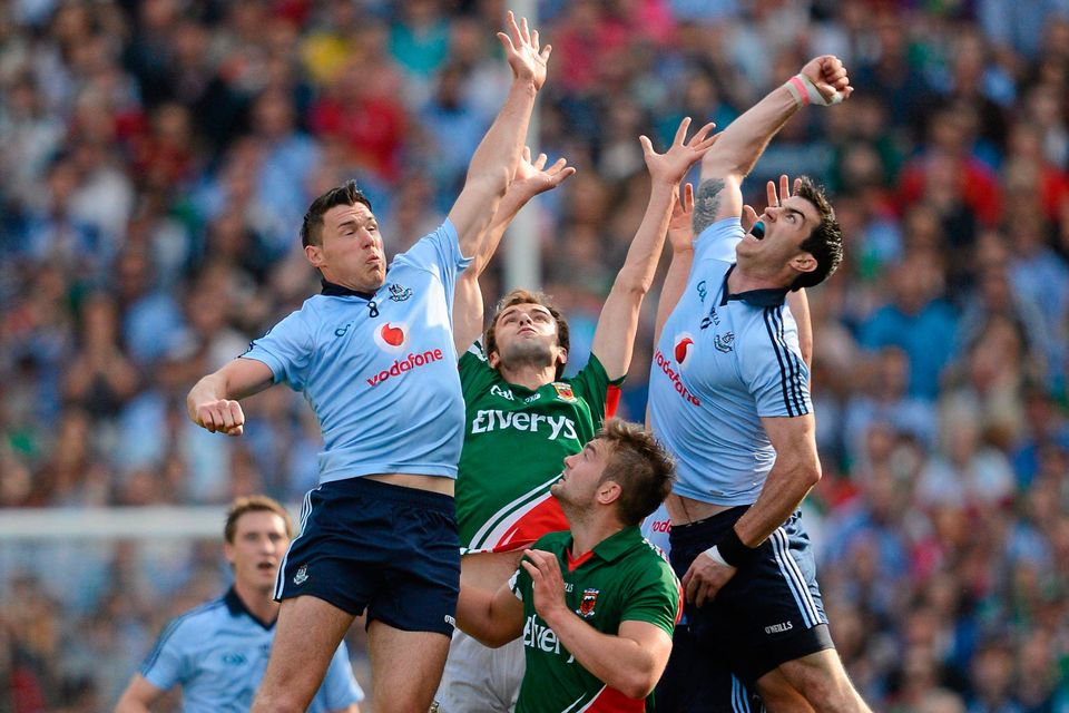 Eamon Fennell (left) and Michael Darragh Macauley in action for Dublin against Mayo duo Enda Varley (left) and Aidan O'Shea in 2012. Photo: Stephen McCarthy/Sportsfile