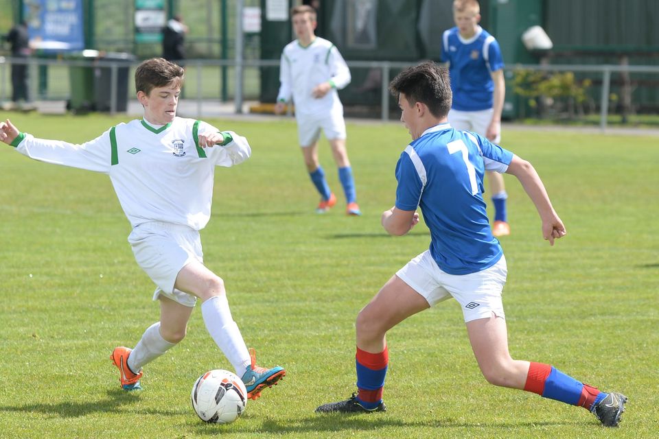 19/05/15.Liam Tracey makes his tackle on Daniel Stewart during the Under 15s soccer final between Colaiste Phadraig CBS and Templeouge College at Peamount Utd.
Pic: Justin Farrelly.