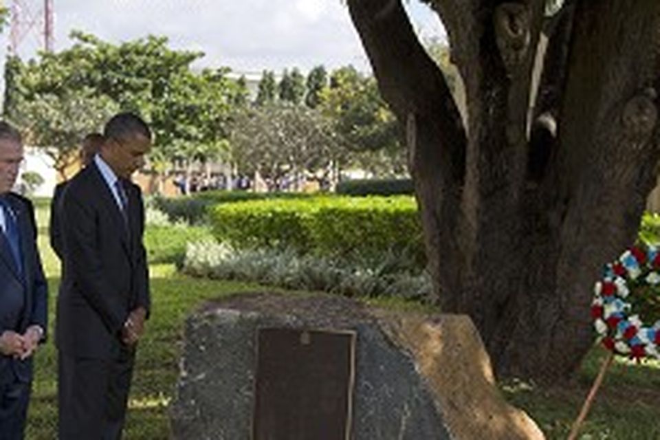 US president Barack Obama and former president George W Bush during a wreath-laying ceremony in Dar es Salaam, Tanzania (AP)