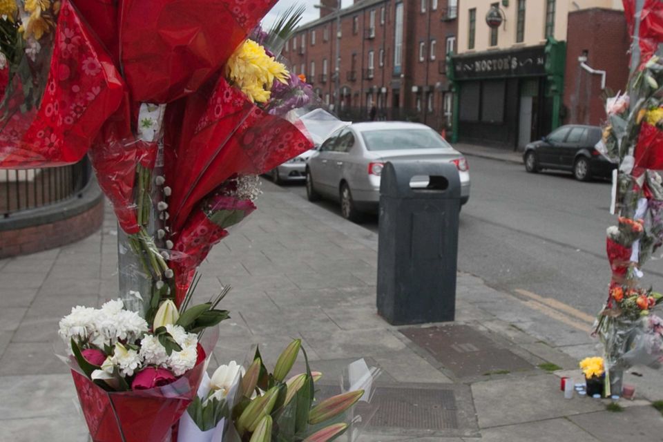Flowers and messages of condolence left at the Sheriff Street scene yesterday, where Martin was gunned down