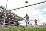 thumbnail: Conor Gormley, Tyrone, kicks the ball in frustration after Alan Freeman scored a goal for Mayo. The goal was subsequently disallowed and a free kick awarded to Mayo.