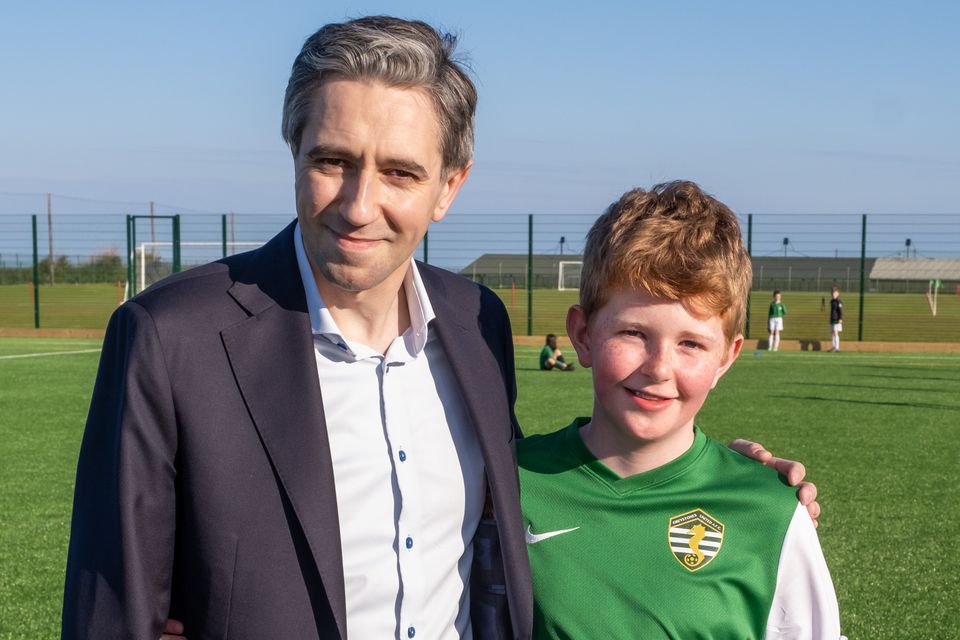 Taoiseach Simon Harris with Daniel Large who plays for Greystones Utd U11s. Photo: Leigh Anderson