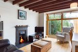 thumbnail: The living room with exposed beams and floor-to-ceiling window