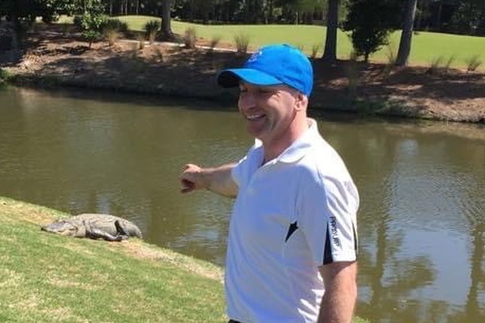 DJ Carey poses for a photo as an alligator ventures on to the green during a round of golf at Kiawah Island in South Carolina in 2015. Photo: Facebook