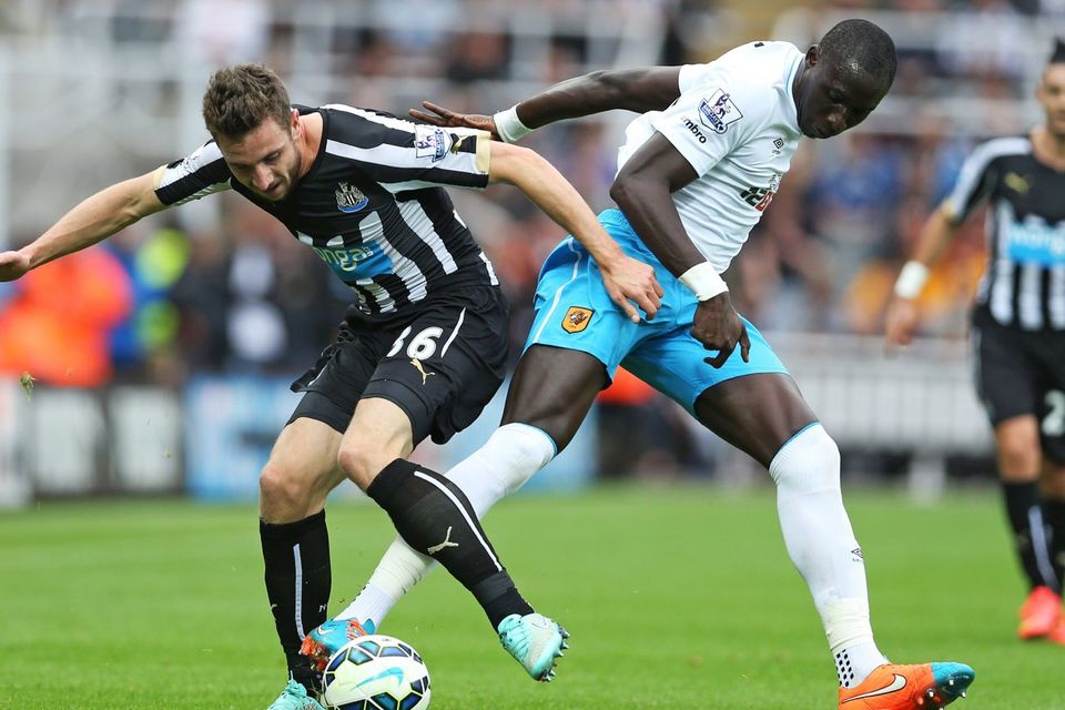 Newcastle United defender Paul Dummett vies with Hull City's Mohamed Diame during the Premier League game at St.James' Park. Photo: Ian MacNicol/AFP/Getty Images