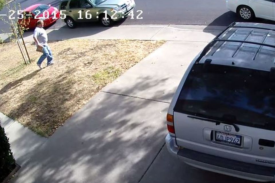 The thief is seen making his way back to his car with the parcel