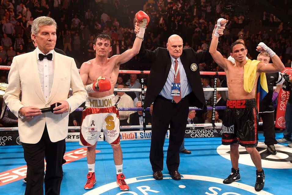 Anthony Crolla (2nd left) after his WBA World Lightweight Championship fight against Darleys Perez was called a draw with announcer Michael Buffer (left), at Manchester Arena, Manchester