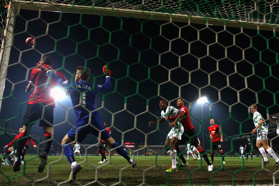 Angel Di Maria (L) of Manchester United heads clear on the goalline as goalkeeper David De Gea covers during the FA Cup Third Round match between Yeovil Town and Manchester United at Huish Park on January 4, 2015