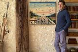 thumbnail: David Orr standing beside his African painting at home in France