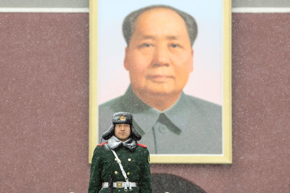 A policeman stands guard in front of a portrait of former Chinese leader Mao Zedong in Tiananmen Square. Photo: Bloomberg