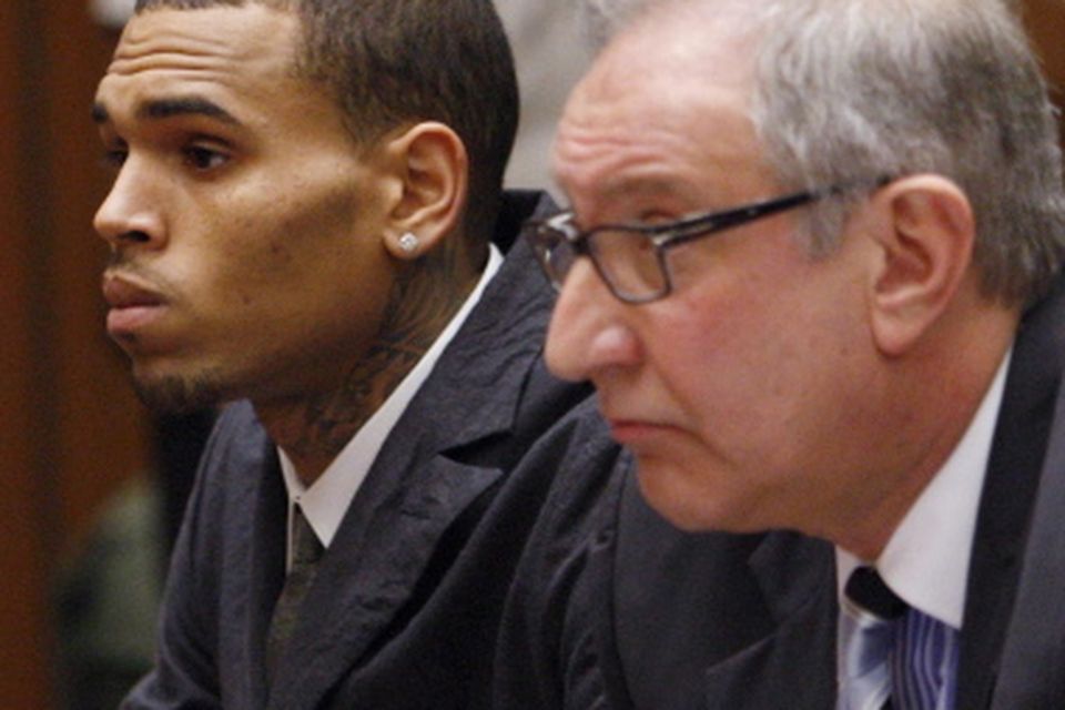 Singer Chris Brown, left, appears in court with his attorney Mark Geragos for a probation revocation hearing at the Criminal Justice Center in downtown Los Angeles on Wednesday, Feb. 6, 2013. Prosecutors are seeking probation revocation because they say they could not find credible evidence that Brown completed his community labor sentence stemming from the 2009 beating of his girlfriend Rihanna. (AP Photo/David McNew, Pool)