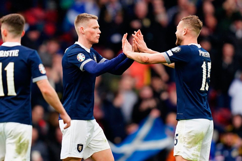Scotland's Scott McTominay (centre) celebrates with team-mate Ryan Porteous after scoring their side's third goal of the game during the UEFA Euro 2024 Group A qualifying match at Hampden Park, Glasgow