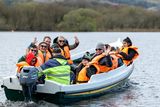 thumbnail: Students of Gaelscoil Faithleann with their parents departing from Ross Castle to the Innisfallen Island for a Mass and Farewell event to celebrate the retirement of Proinsias Mac Curtain Principal of Gaelscoil Faithleann. Photo by Tatyana McGough