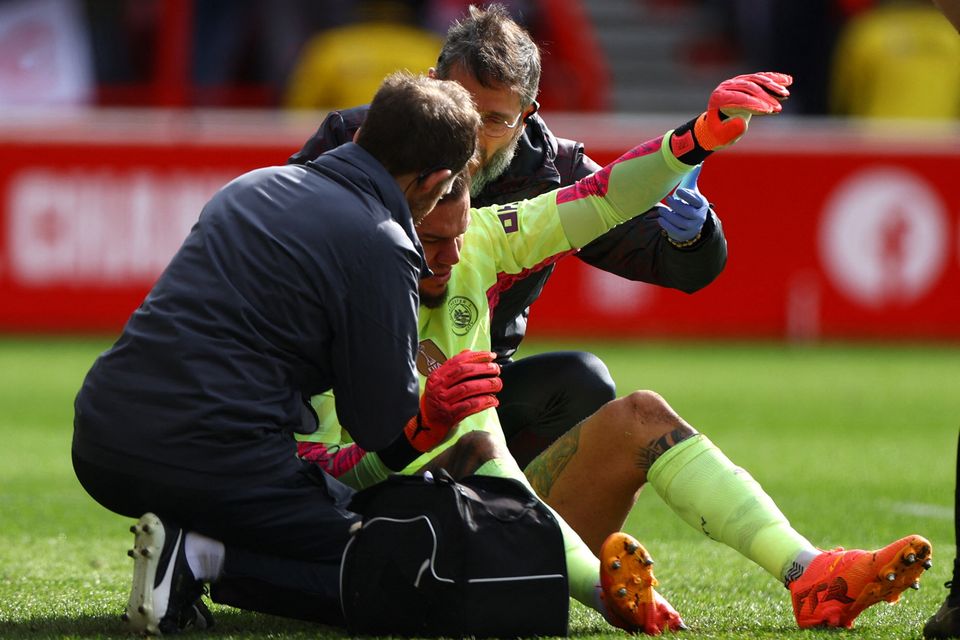 Manchester City's Ederson receives medical attention at the City Ground