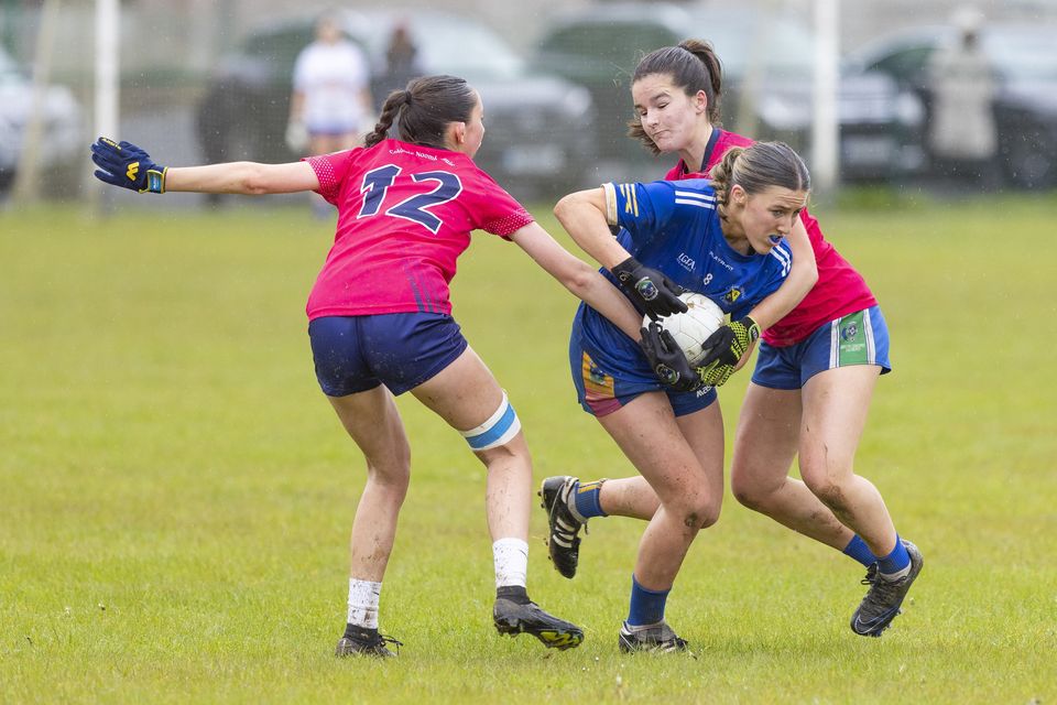 Coláiste Bhríde's Ciara Wafer forces her way past the St. Mary's half-forwards.  