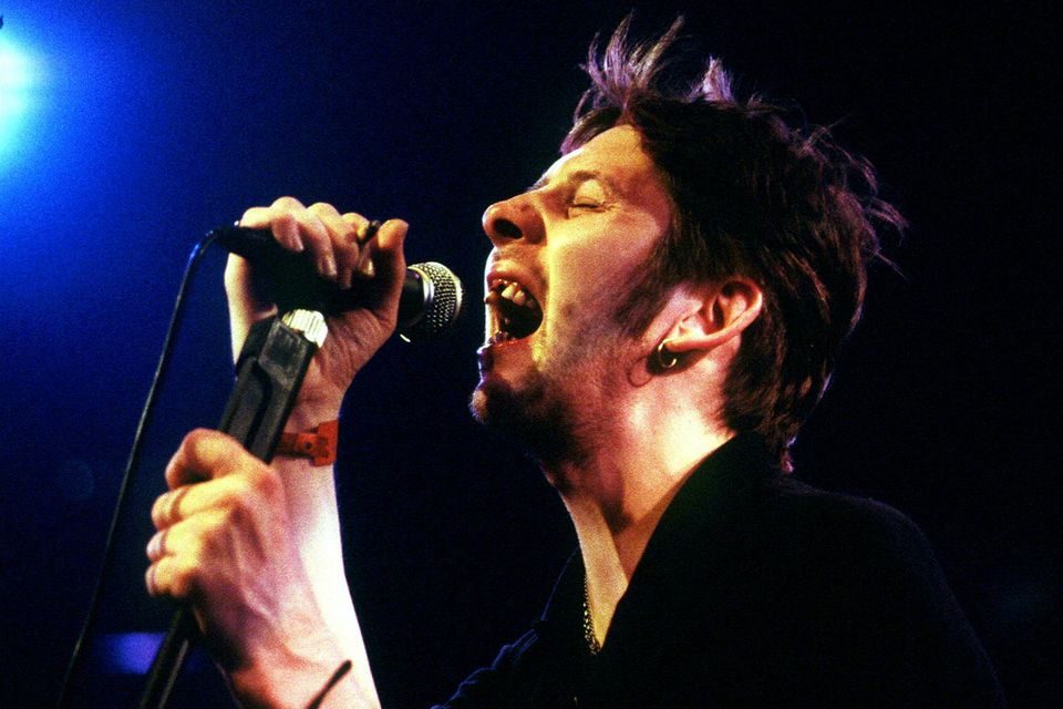 Shane MacGowan, who has died aged 65, performing with The Pogues in the mid-1990s. Photo: Reuters