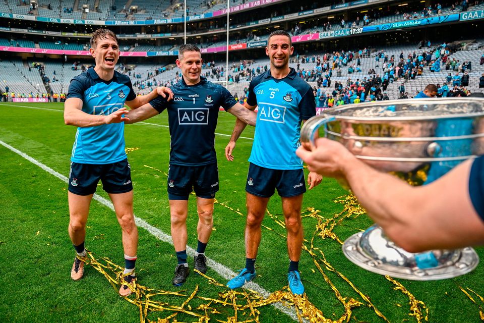 Record nine-time All-Ireland winners Mick Fitzsimons, Stephen Cluxton and captain James McCarthy celebrate with Sam Maguire after Dublin’s All-Ireland final win over Kerry at Croke Park last July. Photo: Brendan Moran/Sportsfile