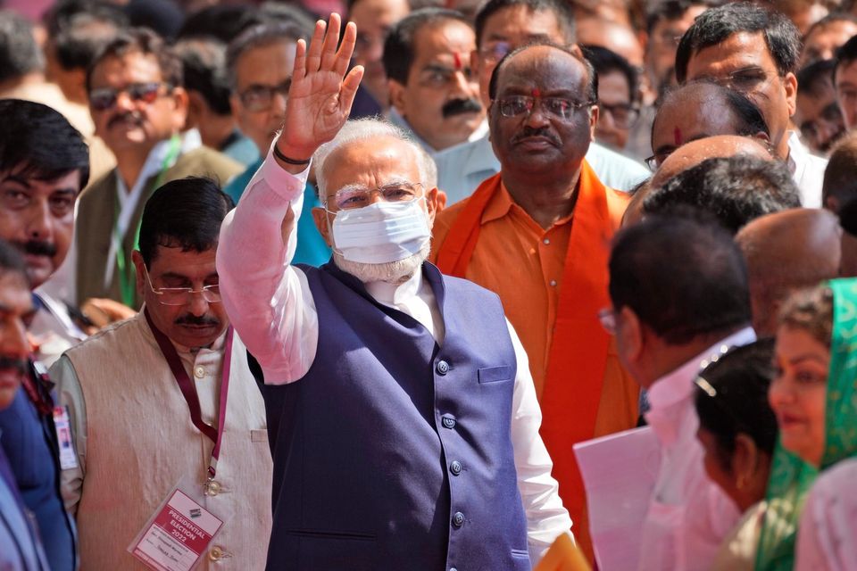 Indian Prime Minister Narendra Modi, center, waves after casting his vote during India's president election at the Parliament House in New Delhi. Photo: Manish Swarup/AP