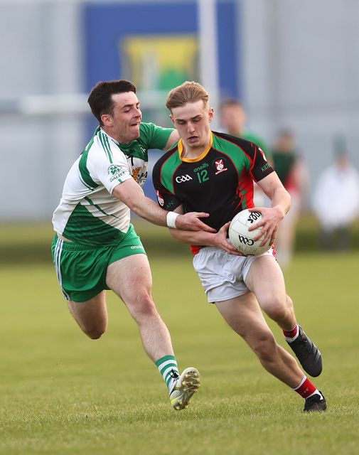 Kiltegan's James Boland tries to find a way pass Paddy Kirwan of Baltinglass. 