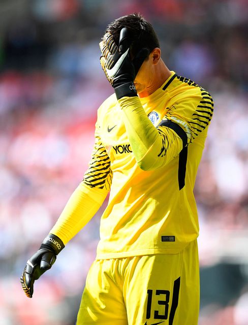 Chelsea's Thibaut Courtois reacts after missing a penalty