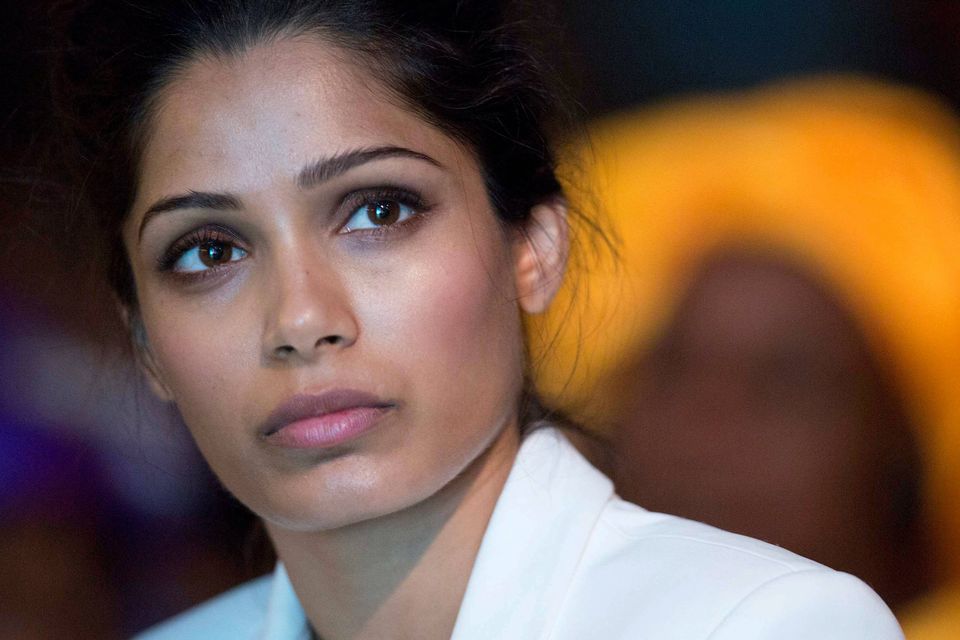 Freida Pinto at the ‘Girl Summit 2014’ yesterday and, below, in ‘Slumdog Millionaire’. Reuters
