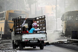 thumbnail: A family on a pick-up truck flees violence in the city of Aleppo.