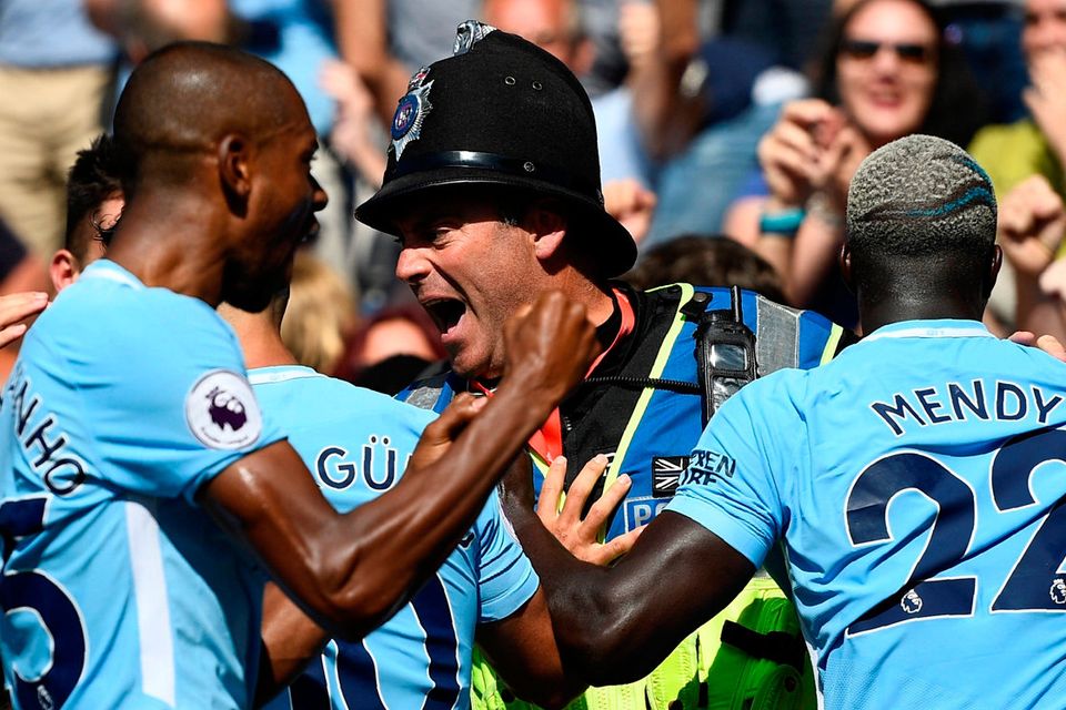 Manchester City's Sergio Aguero and Benjamin Mendy with Police after Raheem Sterling celebrates scoring their second goal. Photo: Dylan Martinez/Reuters