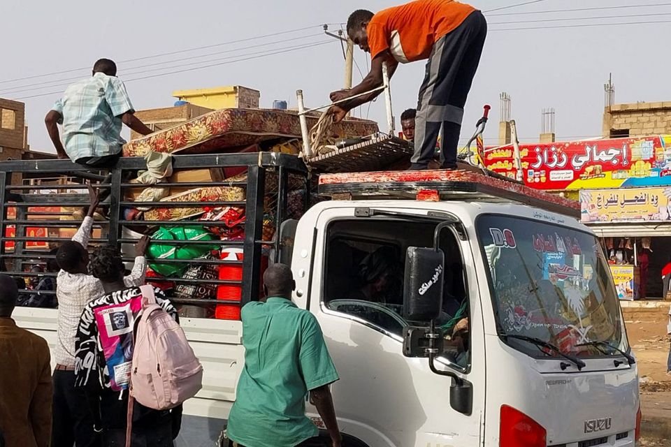 People load belongings onto a truck as they flee the fighting in Khartoum, Sudan’s capital. Photo: Reuters