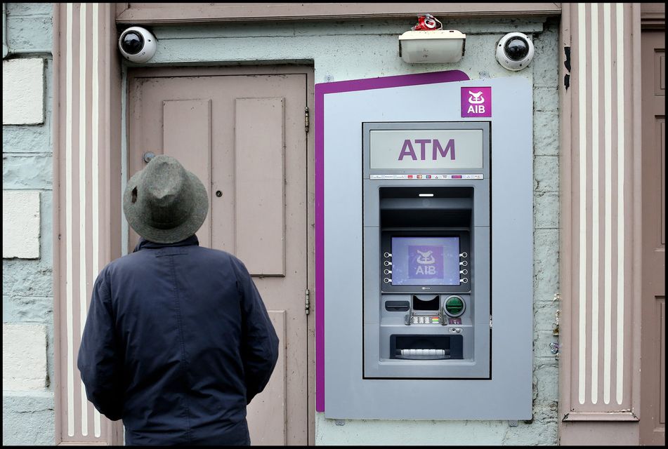 A local passerby takes a closer look at the scene of the ATM foiled raid on the Main Street in Virginia, Co Cavan.
Pic Steve Humphreys