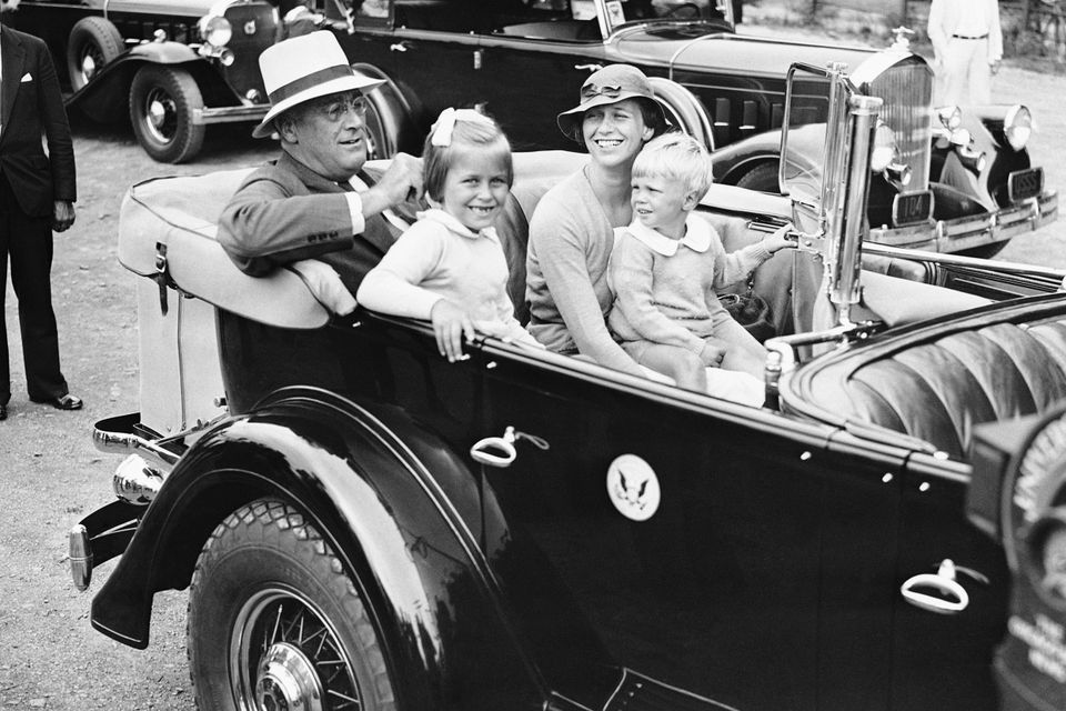 In a 1933 photo, US president Franklin D. Roosevelt sits in his car with his daughter Anna Eleanor Dall and her two children, Anna Eleanor Roosevelt, and Curtis Roosevelt (AP)