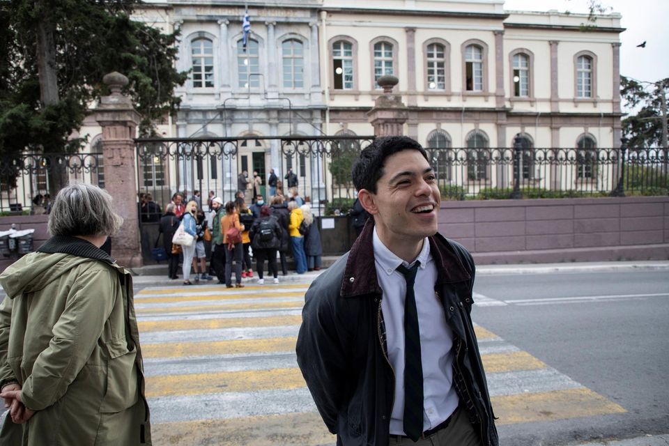 Aid worker Seán Binder, who faces trial over refugee rescues, smiles outside a courthouse on the island of Lesbos, Greece. Reuters